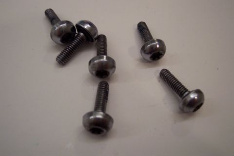 1995 Ford Bronco - Close-up of several metal bolts with hex sockets, likely for automotive use.