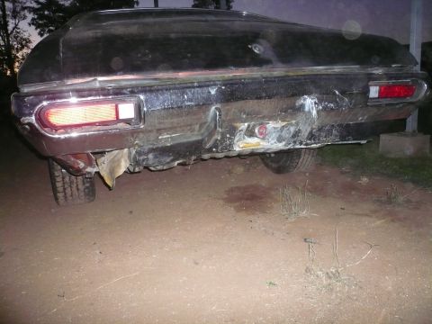 1975 Ford Ranchero - The rear of a vehicle shows extensive damage to the bumper and surrounding bodywork.