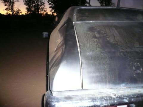 1975 Ford Ranchero - The rear of a dusty pickup truck is shown against a sunset sky.