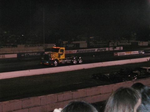 1994 Ford Bronco - Semi-truck racing at Raceway Park during an event at night.