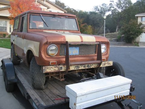 1961 International Scout 800 - This International Scout is on a trailer, showing its front end with a bull bar and a two-tone paint scheme.