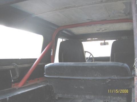 1961 International Scout 800 - The interior of a vehicle is shown, a red roll cage and black seats, with a date stamp of 11/15/2008 in the corner.