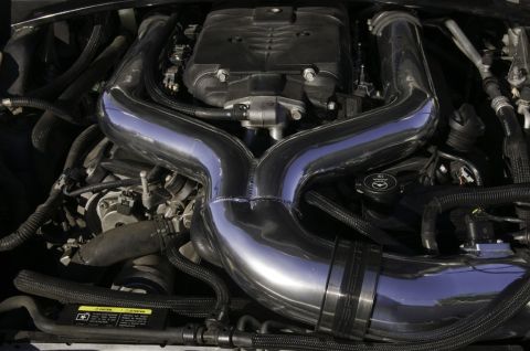 2006 Cadillac STS - Close-up view of an engine bay polished chrome intake piping and various hoses.