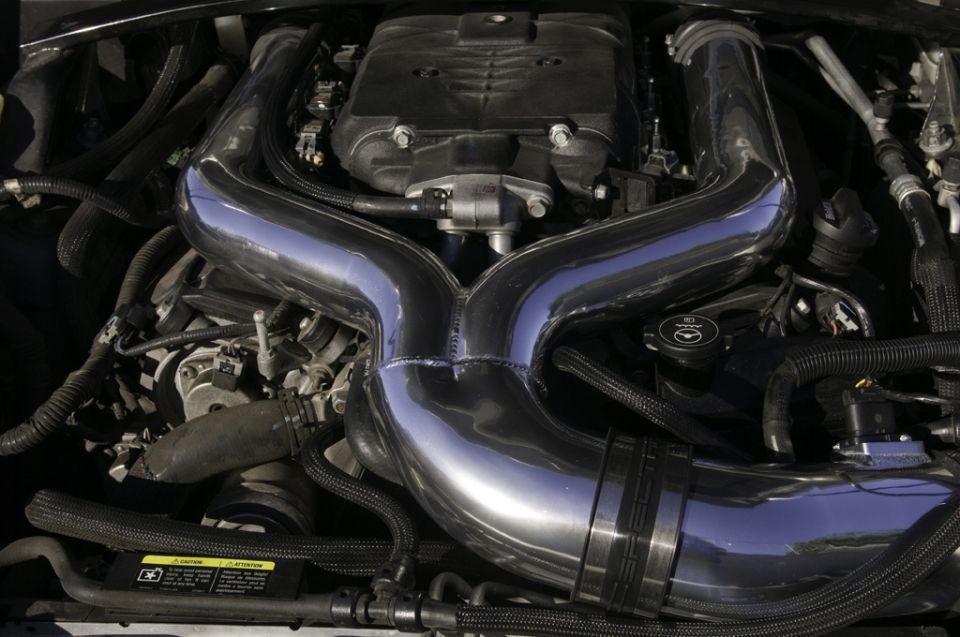 Engine bay with chrome intake pipes and black hoses. Supermotors logo visible