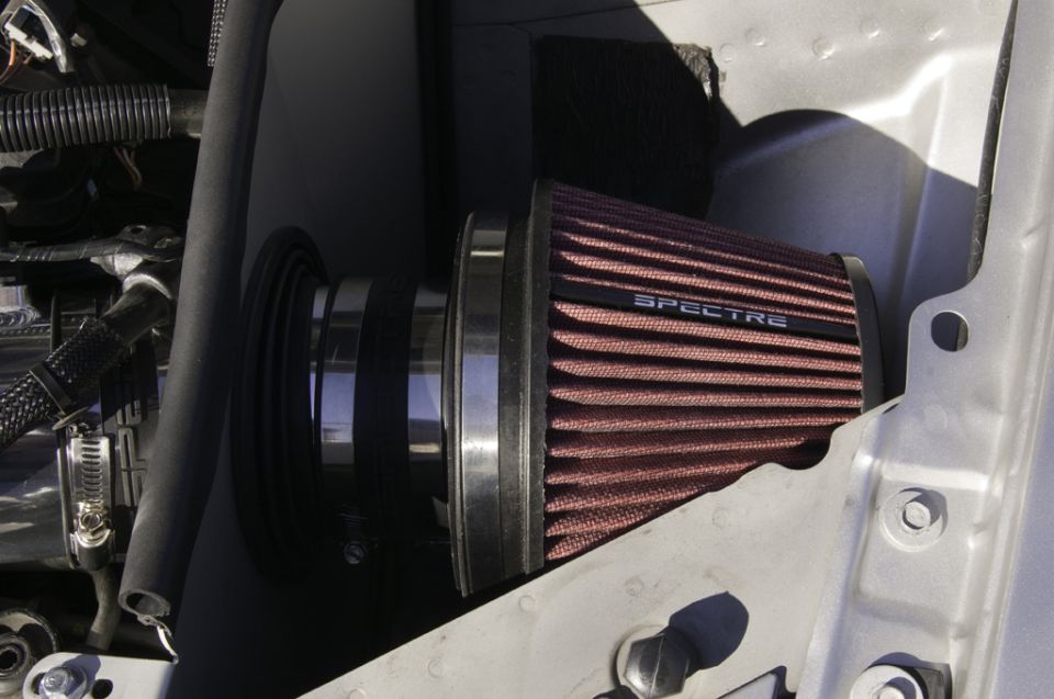 Spectre air filter attached to intake tubing, with engine bay components visible