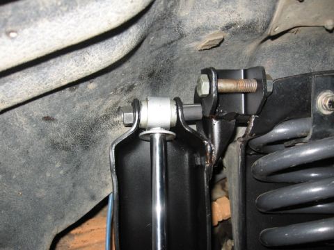 1995 Ford Bronco - Close-up view of suspension components, focusing on shock mounts and springs.