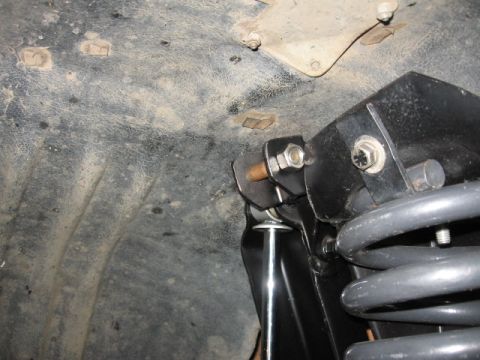 1995 Ford Bronco - Close-up view of the dual front shock and mount assembly, including a gray coil spring.
