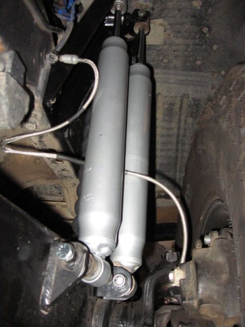 1995 Ford Bronco - Close-up view of dual shock absorber setup on a vehicle's suspension system.