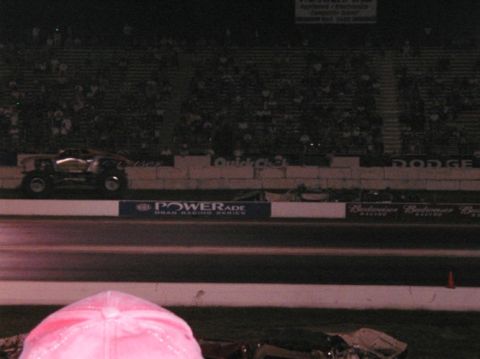 1994 Ford Bronco - A dragster is on the track at a nighttime event with spectators in the stands.