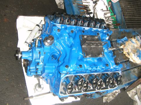 1972 Ford Ranchero - A freshly painted blue V8 engine sits on a workbench, ready for reassembly. The valve covers are off, revealing the internal components.