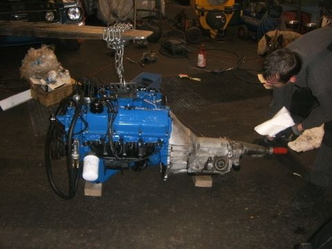 1972 Ford Ranchero - Engine and transmission assembly being worked on in a garage setting.