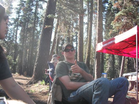 1991 Ford Bronco - A man enjoys a sunny day outdoors, giving a thumbs-up gesture while seated in a camping chair.