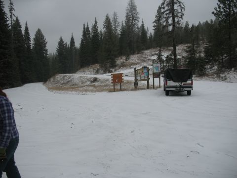 1995 Ford Bronco - Truck parked at a snowy trailhead with forest and signs in the background.