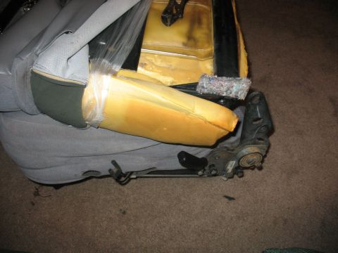 1995 Ford Bronco - Disassembled car seat showing exposed foam and metal frame components.