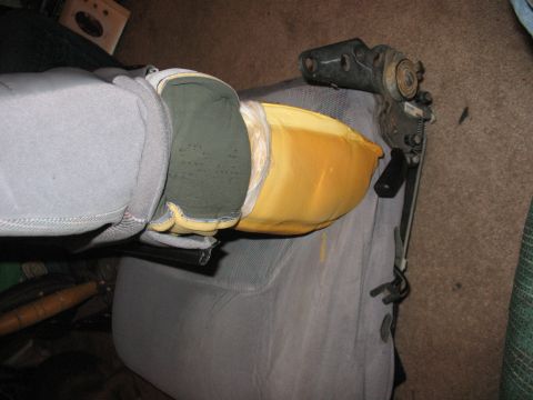 1995 Ford Bronco - The internal mechanism and foam of a car seat are visible, showing wear and tear.