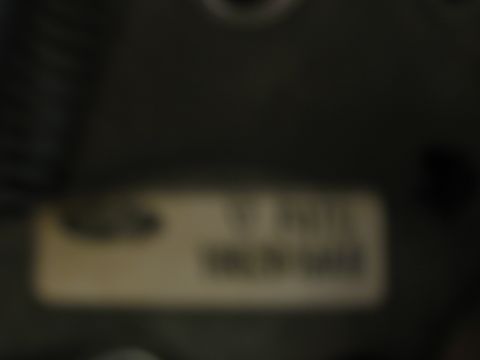 1995 Ford Bronco - A close-up shows a sticker with some text and numbers, possibly a VIN or part number.