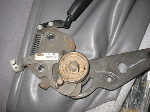 1995 Ford Bronco - Close-up of a seat adjustment mechanism, possibly from a Ford vehicle, showing a label with part number 186269AB.