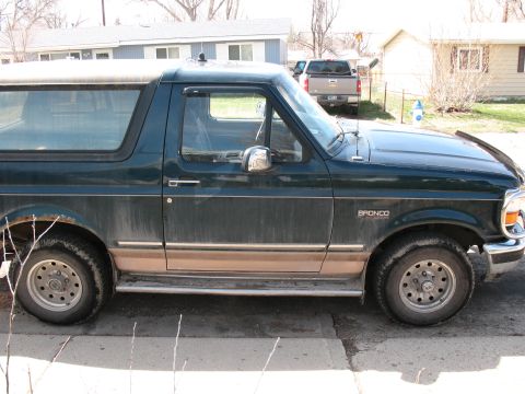 1995 Ford Bronco - This 1995 Ford Bronco is seen from the side, its dark green and tan color scheme.