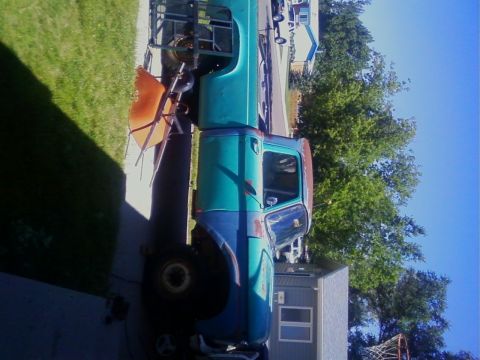 1995 Ford Bronco - This older model truck appears to be in a state of disrepair or restoration.