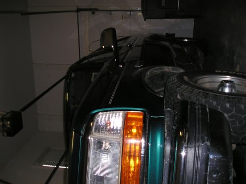 1996 Ford Bronco - This green SUV's front end shows a chrome grille and amber turn signal light.