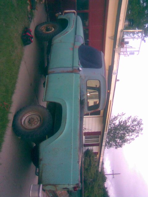 1995 Ford Bronco - This older model pickup truck is seen parked in a driveway.