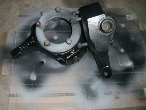 1995 Ford Bronco - Painted vehicle suspension knuckle assembly with bolts, likely for a truck or SUV.