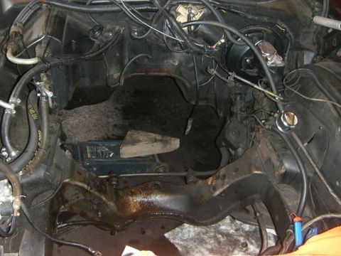 1972 Ford Ranchero - This is a view of the engine bay, showing various components and wiring. The area appears to be undergoing maintenance or repair.