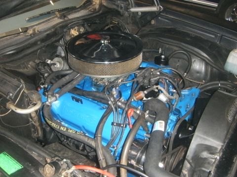 1972 Ford Ranchero - Close-up view of a blue Ford engine with chrome accents and various hoses.