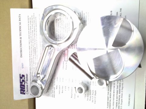 1994 Ford F-150 - A new engine piston and connecting rod are laid out on top of their installation instructions.