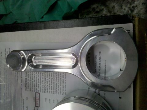1994 Ford F-150 - A close-up view of an aftermarket aluminum connecting rod, likely for an engine rebuild.