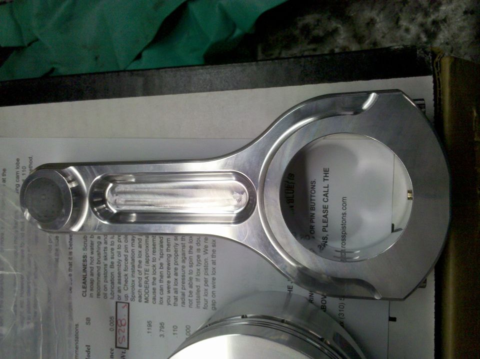 Polished aluminum connecting rod on a Ross Pistons spec sheet with piston nearby