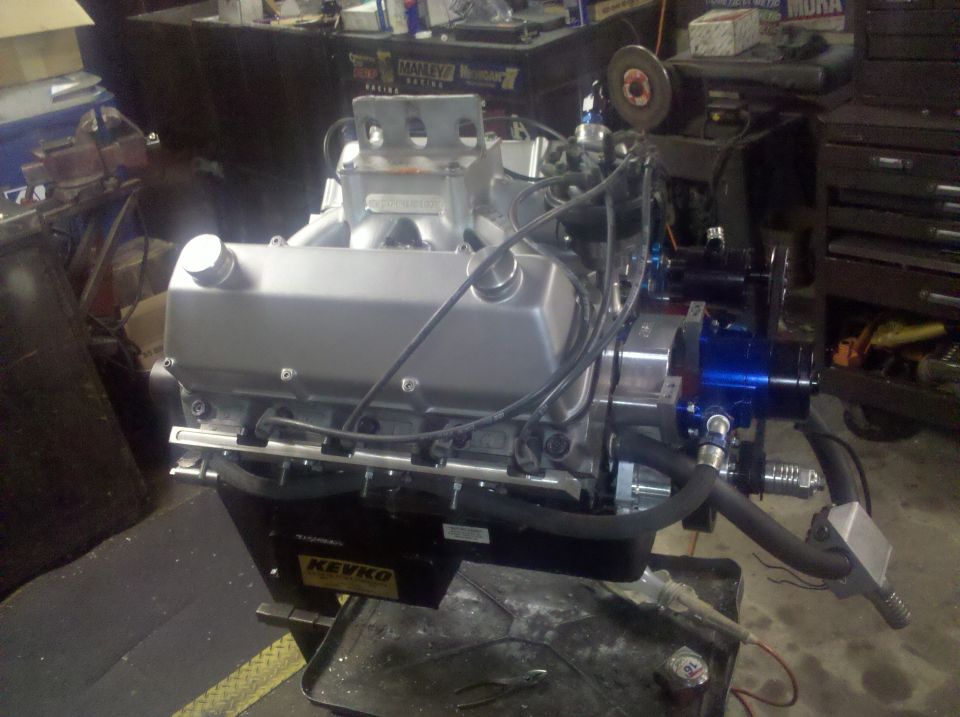 Rebuilt Ford V8 engine on a stand with aluminum valve covers and black KEVKO oil pan
