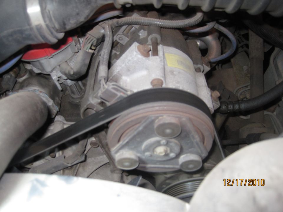 Engine compressor and belt with visible date 12/17/2010 and Supermotors.net logo