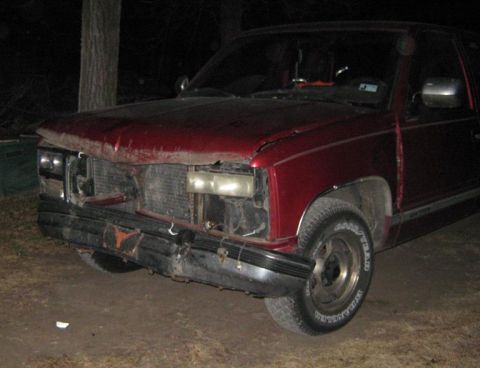 2000 Mercury Grand Marquis - This red pickup truck has a heavily damaged front end, including the bumper, grille, and headlights.