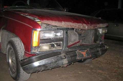2000 Mercury Grand Marquis - This red pickup truck has significant damage to its front end, including a bent hood and exposed grille.