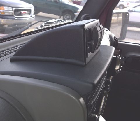 2007 Jeep Wrangler - Interior view of a vehicle dashboard with an aftermarket accessory box containing power outlets.