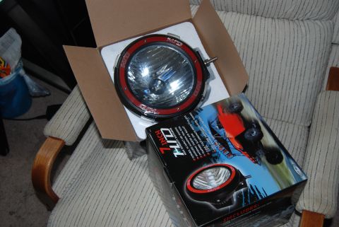 1982 Ford Bronco - New 7-inch HID driving lights are shown, one removed from its packaging.