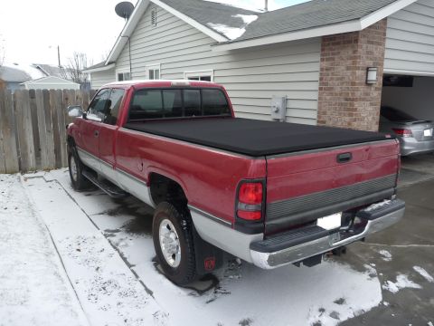 1997 Dodge 2500 - This 1997 Dodge 2500 pickup truck is seen from the rear, parked in a snowy driveway next to a house.