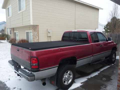 1997 Dodge 2500 - This 1997 Dodge 2500 pickup truck is shown from the rear three-quarter angle, a black tonneau cover over the bed.
