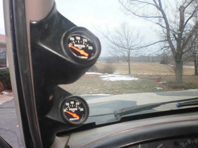 Interior shot of two gauges, one for water temp and one for transmission temp, mounted on the A-pillar