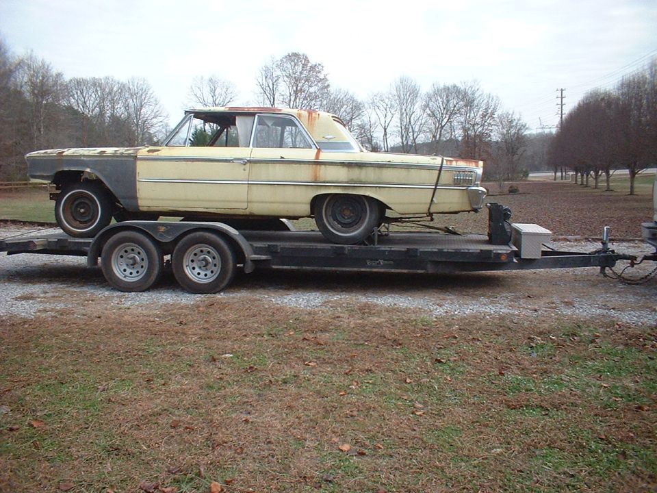 1963 Ford Galaxie coupe on a dual-axle car trailer, side view