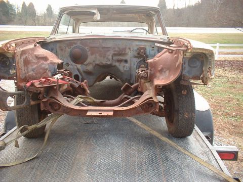 1963 Ford Galaxie - The front end of a heavily rusted 1963 Ford Galaxie is secured to a trailer for transport.