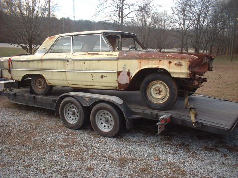 1963 Ford Galaxie - A weathered 1963 Ford Galaxie sedan is seen being transported on a trailer.