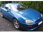1993 Mazda MX-3 - A blue 1993 Mazda MX-3 is shown from the front three-quarter angle.