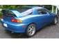 1993 Mazda MX-3 - A blue coupe is parked outdoors with its trunk open, showing a rear quarter view.