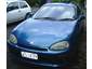 1993 Mazda MX-3 - A blue coupe is parked next to a white vehicle. The license plate is visible.