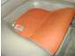 1993 Mazda MX-3 - A close-up of an orange, heart-shaped pillow resting in a white basin.