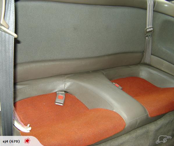 Coupe rear bench seat with grey leather bolsters and orange cloth inserts