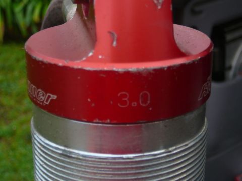 1988 Ford Bronco - A close-up view of a red shock absorber component, showing the "3.0" designation and part of the manufacturer's name.