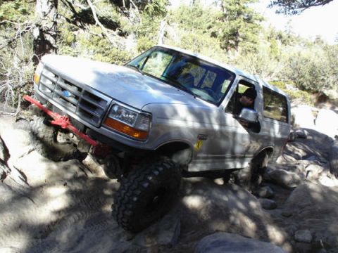 1996 Ford Bronco - This 1996 Ford Bronco is shown tackling a challenging off-road course with large rocks.